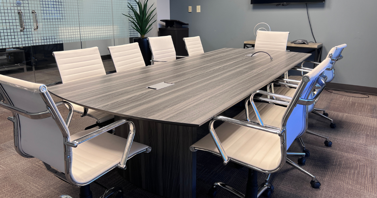 Spacious conference room with long table, ergonomic chairs, and modern decor